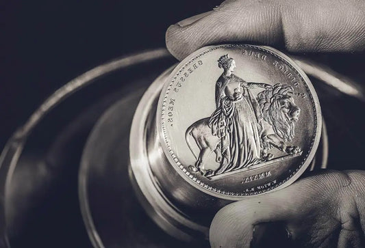 Royal Mint Great Engravers coins including Una and the Lion, Three Graces, and Gothic Crown arranged together in a collector display.